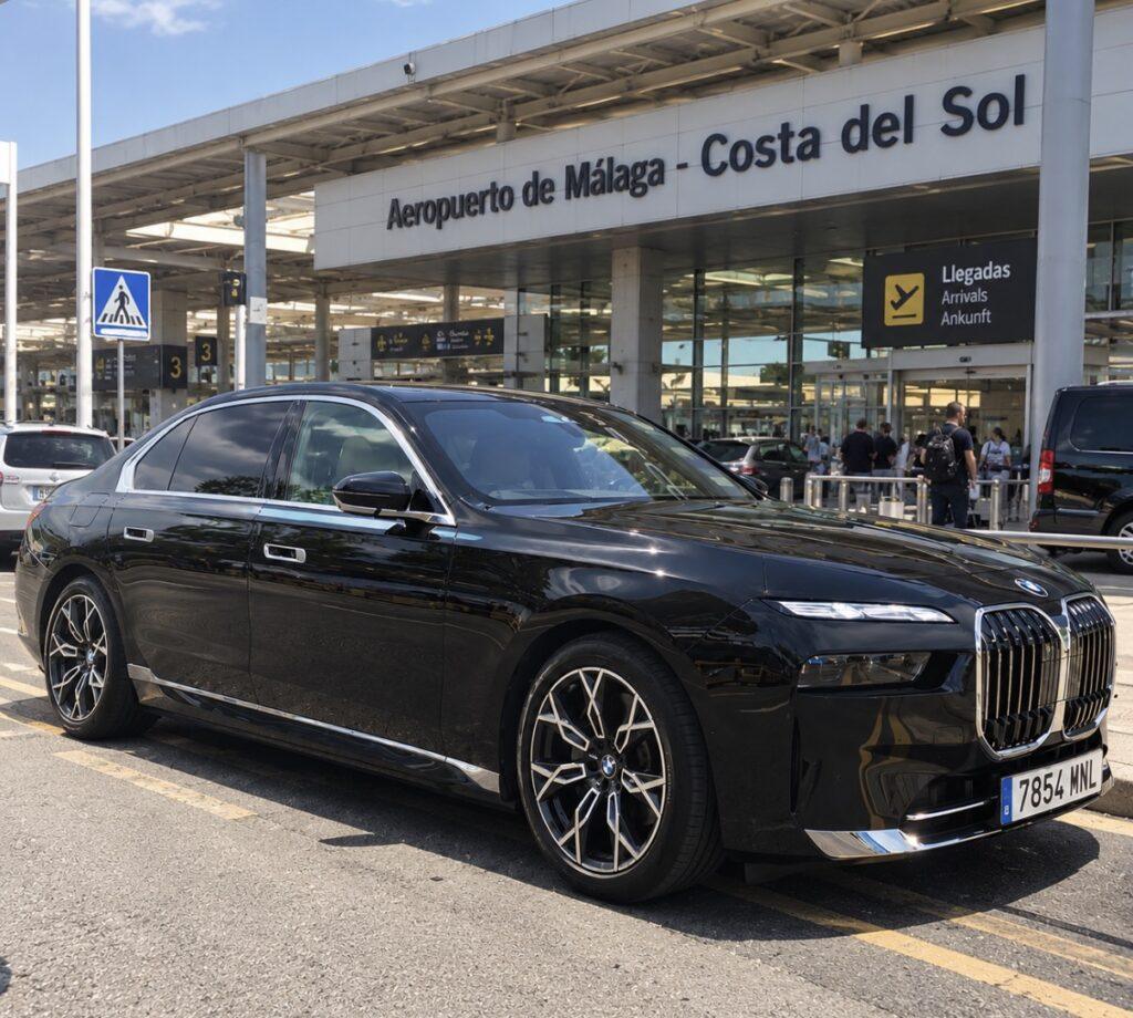 Black BMW saloon outside the arrivals entrance at M&aacute;laga-Costa del Sol Airport.