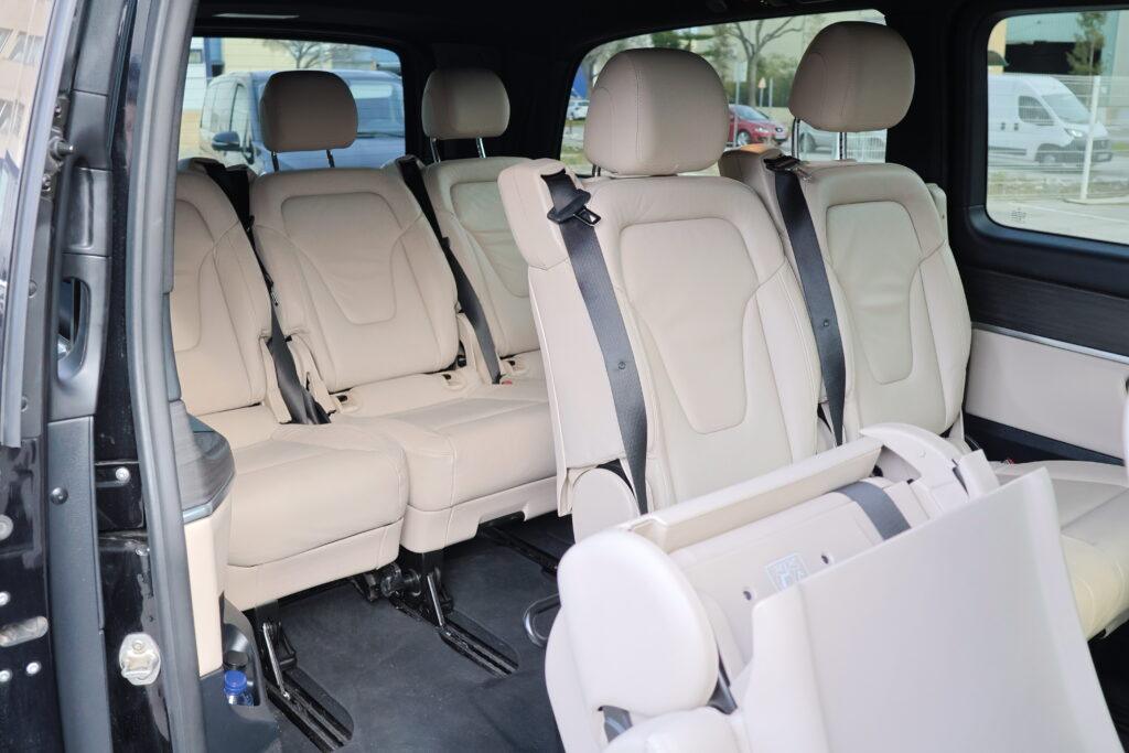 Light leather passenger seats and a folding table inside a Mercedes-Benz V-Class.